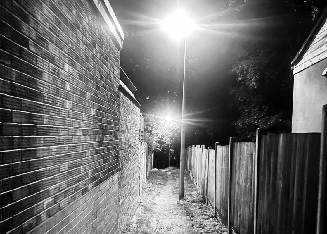 Dark urban alley at night symbolising potential danger and the need for situational awareness